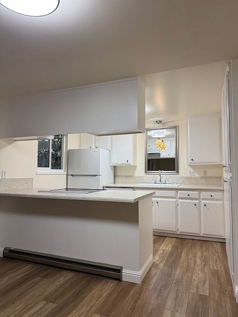 kitchen with new countertops, refrigerator, glass top range, dishwasher, large double cast iron sink