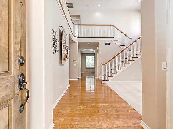 Two story Living Room, hardwood floors, lots of Natural Light.