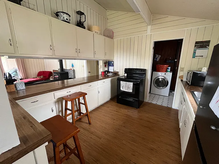 Kitchen leads to laundry room and door to side deck.