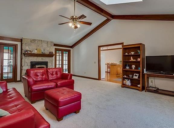 The spacious great room with cathedral ceiling opens to the kitchen/dining room and the sun room for wonderful open flow
