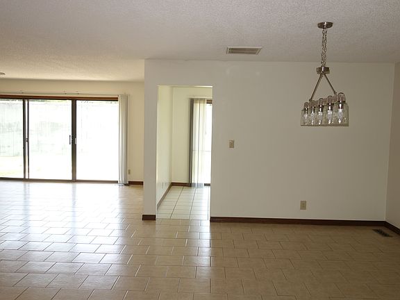 View just inside the front entry. Dining area on the right and Living room on the left. Kitchen entry straight ahead.
