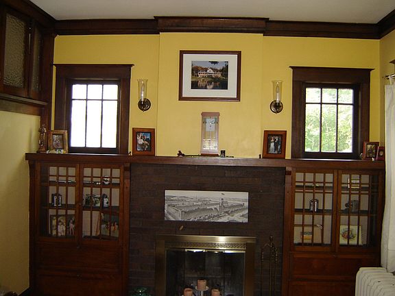 Front room w/fireplace framed by built-ins & crown moulding
