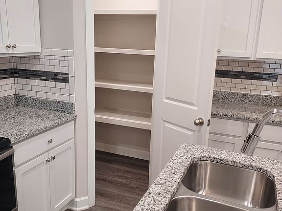 Kitchen with the pantry door open.