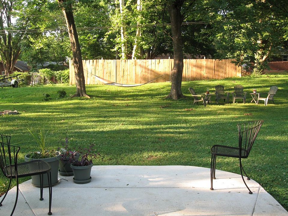 fenced in backyard with small patio