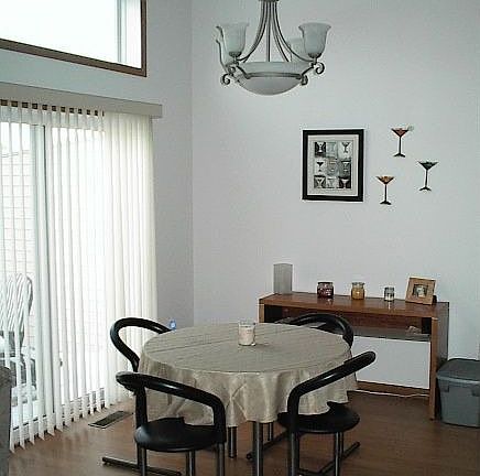 Dining area and kitchen feature wood-laminate floors
