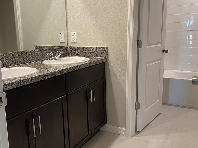 second full bathroom with a double vanity and separate shower room