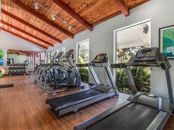 Fitness center with cardio and strength training equipment.