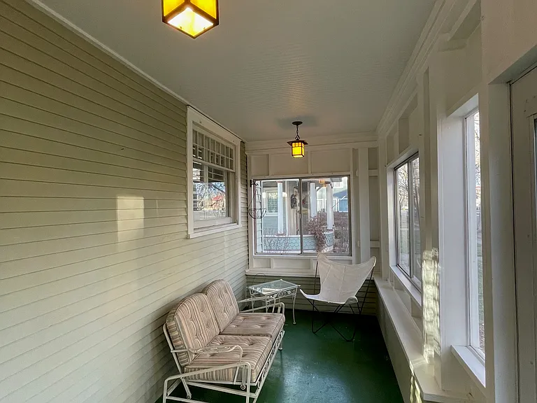 Cozy enclosed front porch.