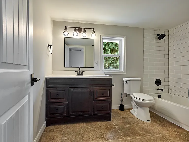 2nd Floor Full Bathroom with brand new tub, tile surround, and built-in shelving.