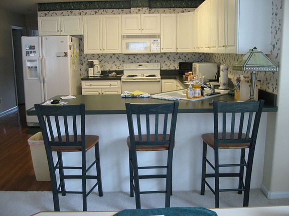 All Electric Kitchen with Tall Cabinets and Wide Eat-In Bar