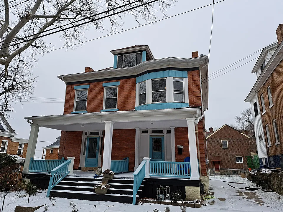 It's the brick house with the blue trim!