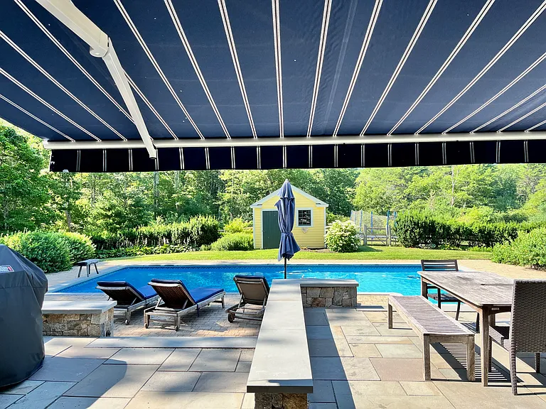 Patio and pool area with retractable awning.