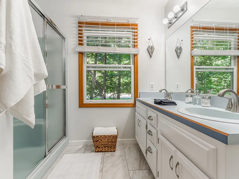 Primary room bathroom with double sink, stand-up shower, and extra-large bathtub