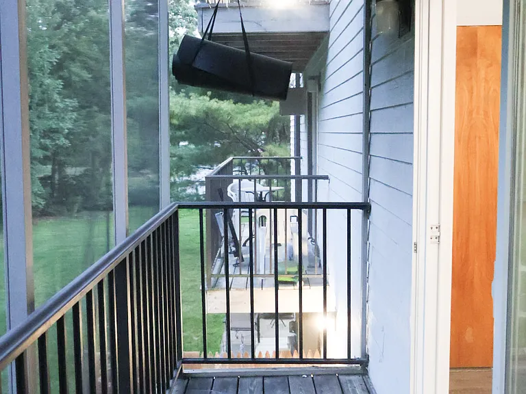 Private Balcony _ Accessible Directly from the Living Room and Overlooking the Backyard. Fully Enclosed with Protective Screening for Added Safety for Children while also helping keep mosquitoes and other insects out.