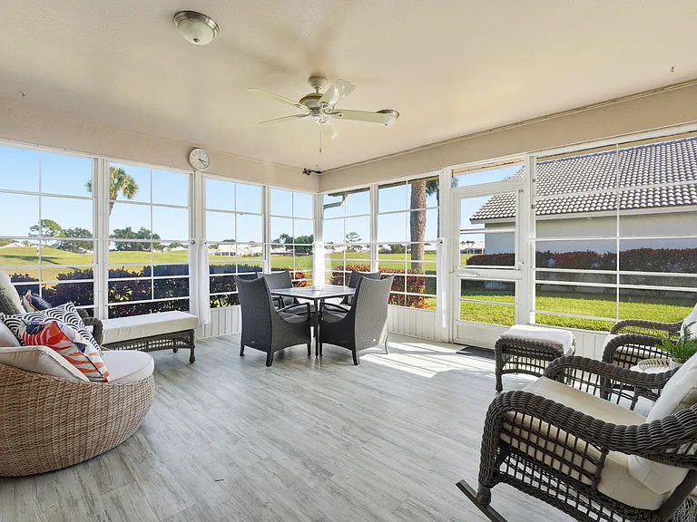 Lanai with sunrise views of the driving range and golf course beyond
