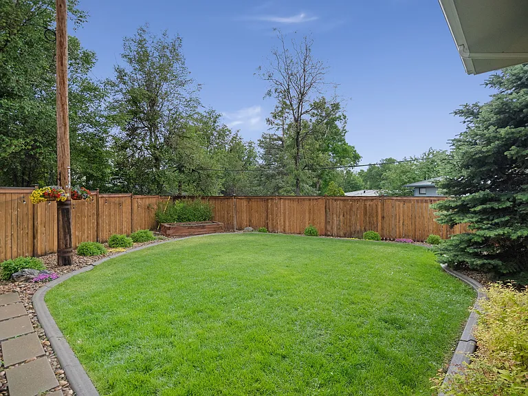 Professionally landscaped backyard with privacy fence. Features a raised garden bed on a drip system. Great play area or entertaining space.