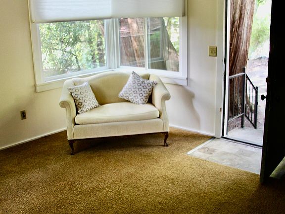 Living room, front door open.