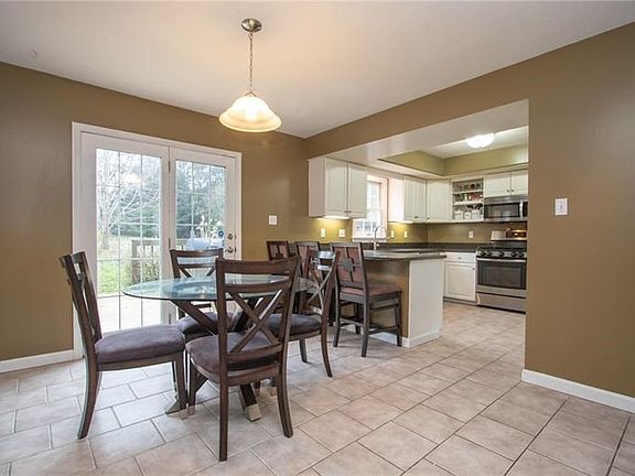 A sizable 19X13 eat-in-kitchen is updated with granite counter tops, tile floors & new SS appliances.