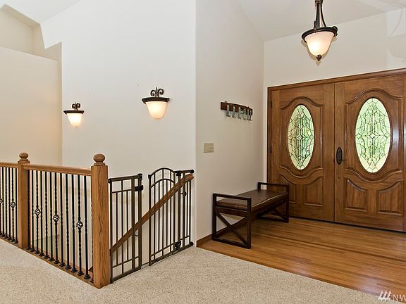 The impressive entry way demonstrates the use of wood and metal throughout the home.