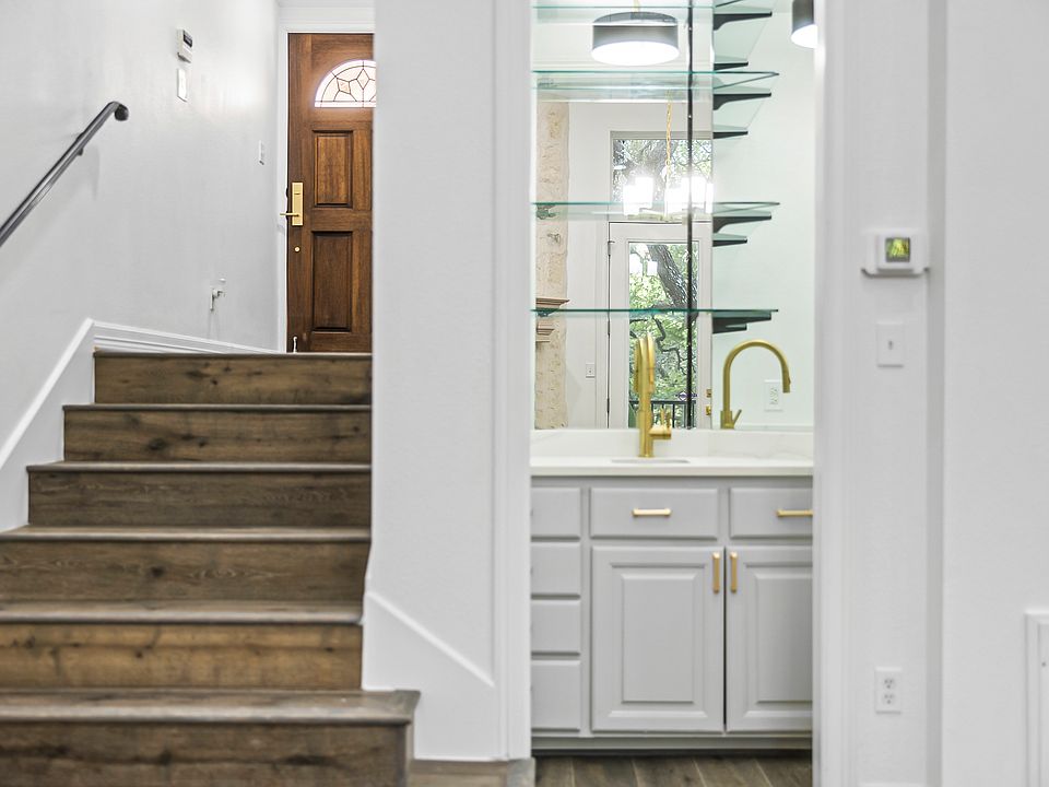 Steps down from the entry into the living room. Pictured is the wet bar