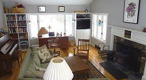 Peaked ceilinged fireplaced LR