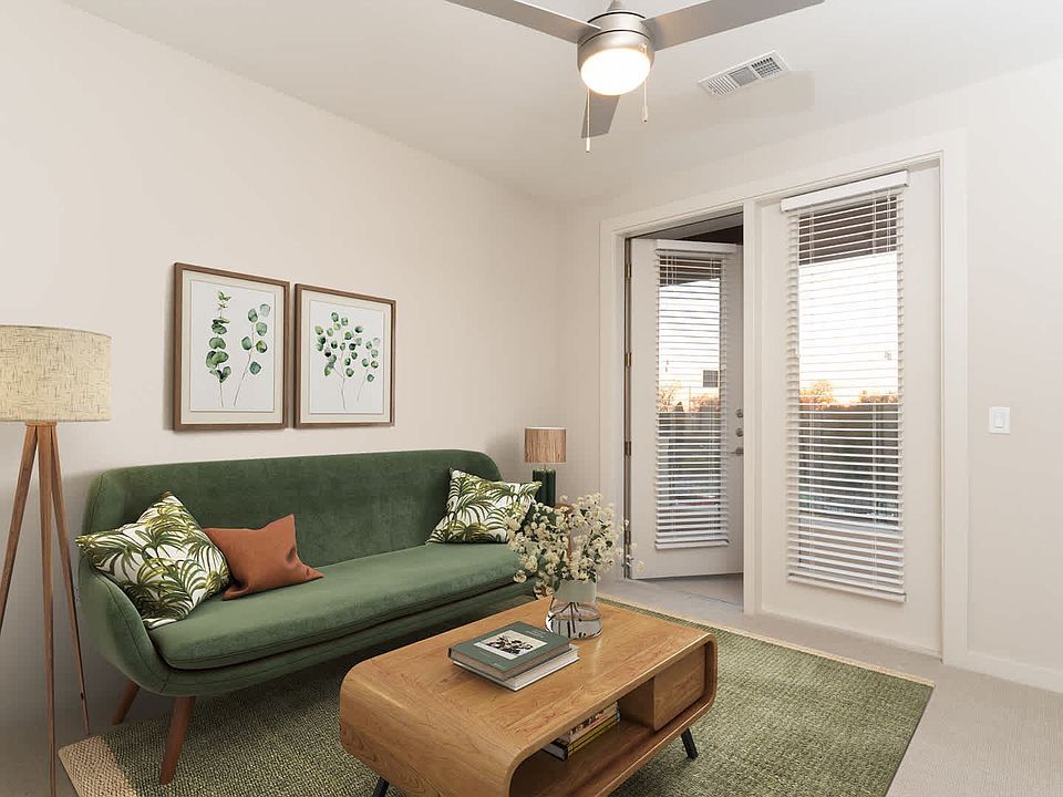 Carpeted Living Room with Balcony