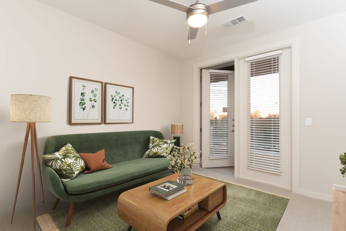 Carpeted Living Room with Balcony