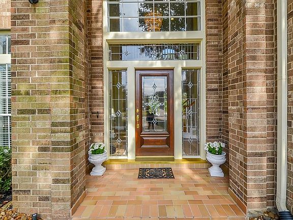 Warm and inviting entry. Leaded glass door with transoms allow plenty of natural lighting into the home. Tiled front porch a plus!