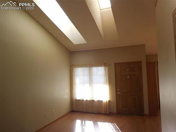 Bright living room has vaulted ceiling with 2 skylights.