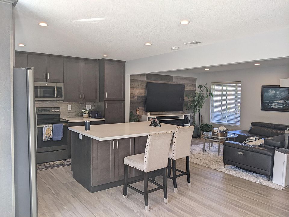 First foor kitchen & family/living area great room. Main entrance & stairs are on the right . View is from the back door that leads to the enclosed patio and separate two-car garage.