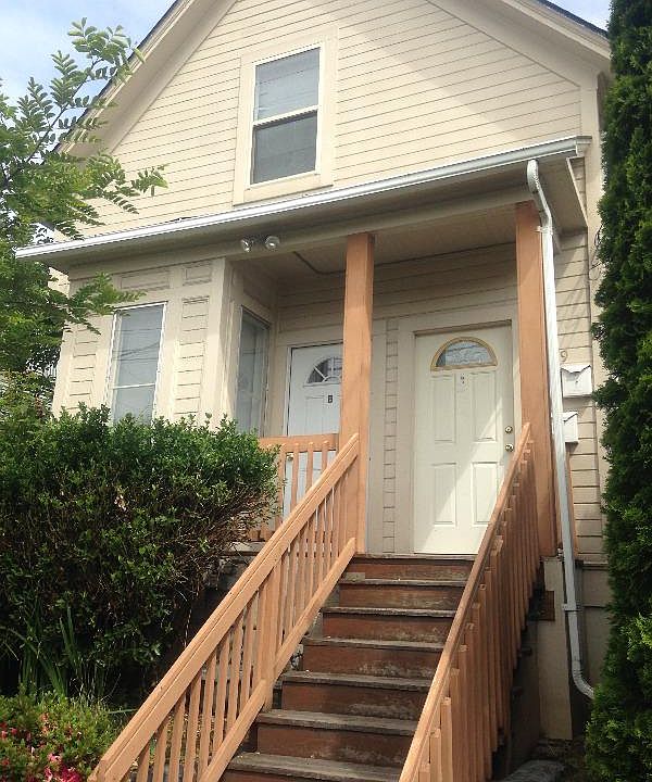 south side of tri-plex front porch (left side door)