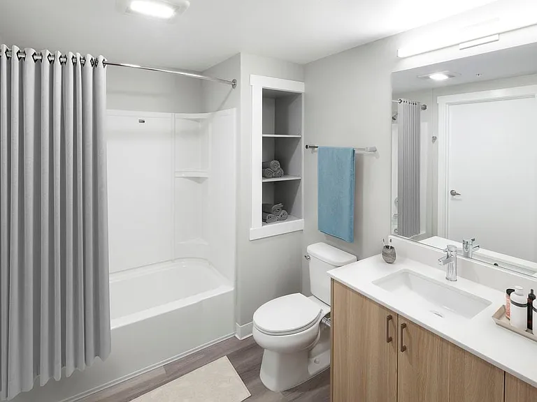 Phase II - Scheme D Bath with oak cabinetry, white quartz countertop, and hard surface flooring