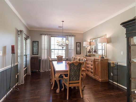 Youâll appreciate the view of the front garden through the large window, the high ceiling, crown molding, chair railing, Mindful Gray neutral paint and the newer, hand-scraped rustic hickory floors with varying widths and plank lengths.