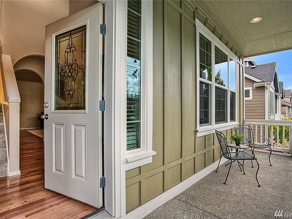 An expansive covered country porch provides a perfect spot to relax, take in the views and enjoy a morning cup of coffee or afternoon iced tea. 