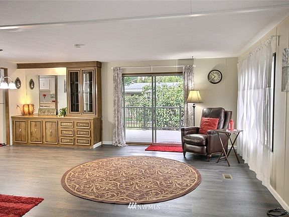 The living room is very large and boasts a sliding glass door to composite deck with metal railing and wheel chair ramp from the street. It also offers a fresh coat of paint!