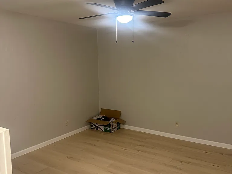 Living room with new flooring and new ceiling fan