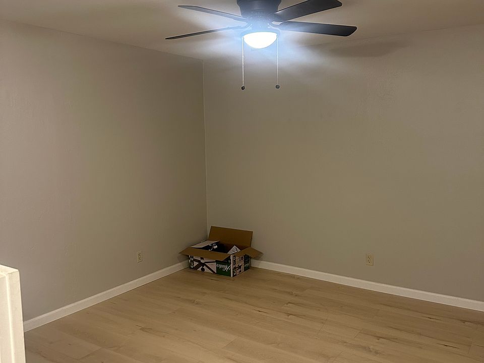 Living room with new flooring and new ceiling fan