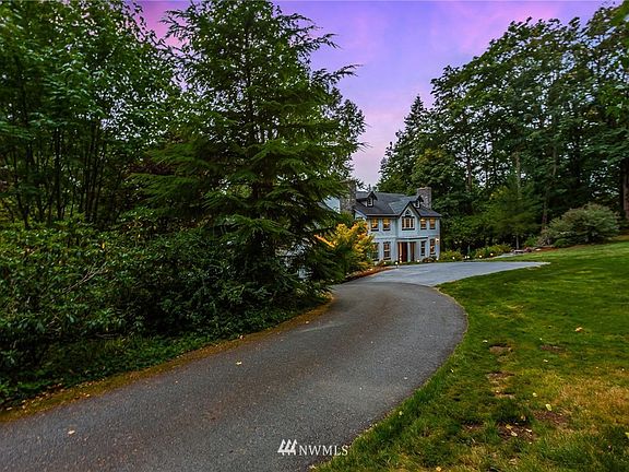 Down a private lane, enjoy 4.5 acres wrapped in old growth trees - step outside and you wont even see neighboring houses