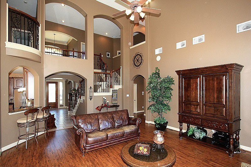 Gorgeous! Open Floorplan; Soaring ceiling; Wrought Iron on Stairs. 