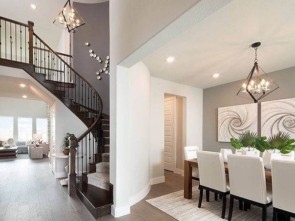 The Cedar plan boasts a grand entrance with curved staircase featured at The Enclave at Oak Grove.