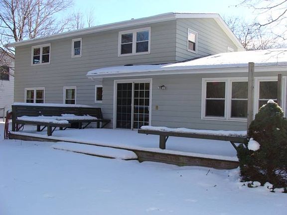The backside of the house with the deck in the foreground