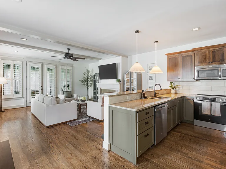 Fully equipped kitchen with stainless steel appliances. Bar countertop includes seating for 4.