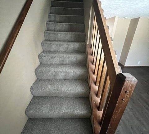 Stairs up to the two bedrooms and main bath