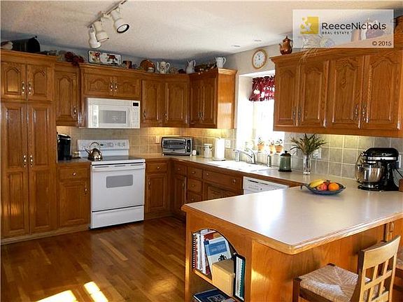 Pantry, plentiful cabinets, and breakfast bar.