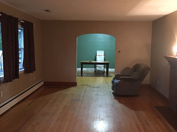 Living room leading into the dining room which has a door to