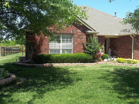 Front left side with two cascading mature trees for an easy maintenance front yard.