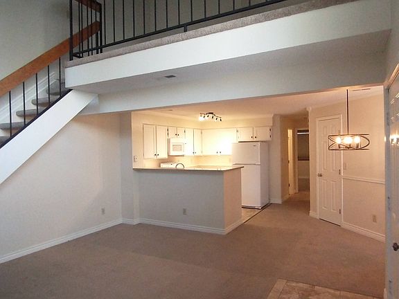 living room, kitchen and dining area, and upstairs loft. Carpets are in excellent condition, professionally cleaned, and neutral sand/taupe color.