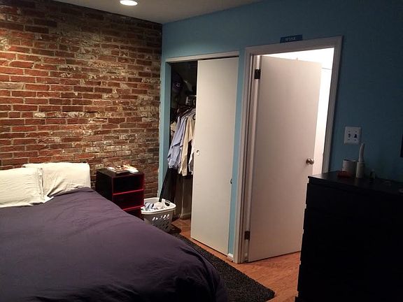 Bedroom w/ exposed brick