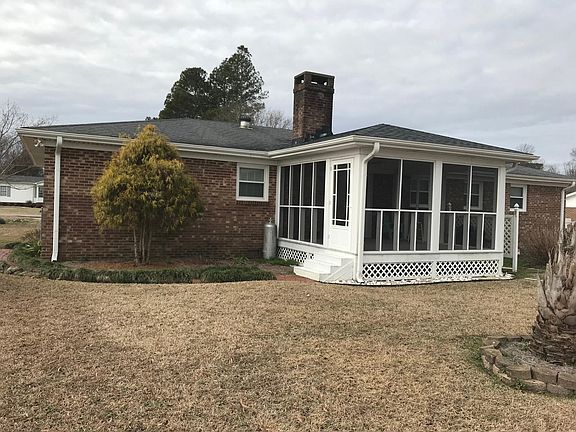 Screened in Porch with ceiling fan with a BrickWalkway