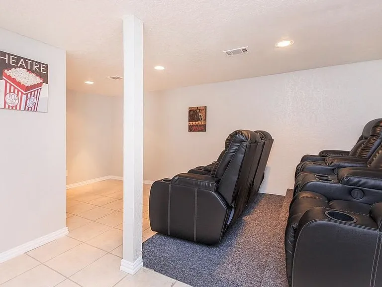 Community movie theater with comfortable recliners and large-screen projection_perfect for movie nights!